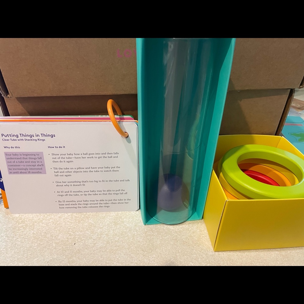 Lovevery clear tube with stacking rings and baby ball